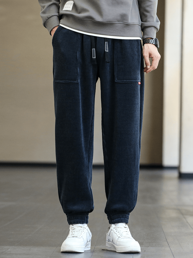Men's corduroy joggers with elastic hem and drawstring closure, featuring pocket details. Perfect for casual, stylish comfort.